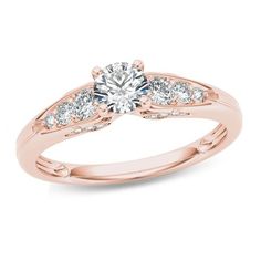 a rose gold engagement ring with three stones