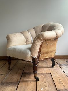 an old chair sitting on top of a wooden floor