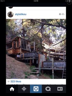 an instagram photo of some wooden houses on a hill with trees in the background