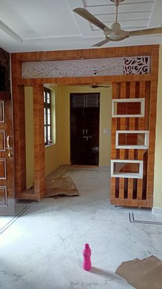 an empty room with wood paneling and a pink object in the middle of it