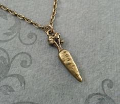 "This listing is for a brass carrot charm necklace. You'll be able to choose your chain length and style at checkout by using the \"Chain Length/Style\" drop-down menu. **Please see the second photo for scale! This is a VERY SMALL charm. If you're on the mobile site, just swipe to the side. :) - - - - - - - This is our third shop for jewelry. If you're looking for something a bit more \"personalized\", then just follow these links: www.etsy.com/shop/metalspeak www.etsy.com/shop/metalspeaktoo - - Carrot Jewelry, Carrot Necklace, Bronze Necklace, Vegan Gifts, Small Charms, Brass Necklace, Bridesmaid Necklace, Letter Charms, Star Fashion