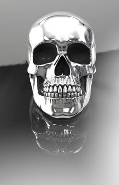 a silver skull ring with black eyes