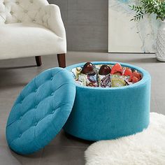 a blue ottoman sitting on top of a white rug