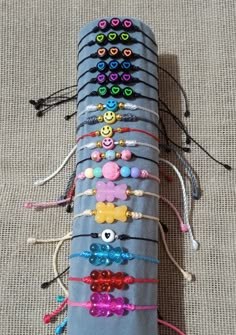 a long gray case with many different colored beads on the top and bottom, sitting on a carpeted surface