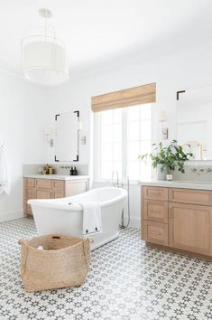 a bathroom with a tub, sink, and window in the middle of it is shown