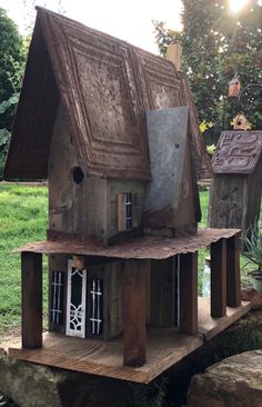 a bird house made out of wood and metal