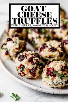 goat cheese truffles with cranberries, walnuts and honey on a white plate