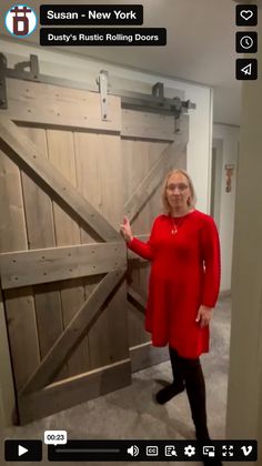 a woman standing in front of a wooden door