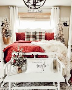 a white bed sitting in a bedroom next to a red and white comforter on top of a rug