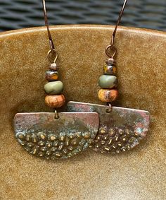 Rustic antique Hammered copper dangle earrings with jasper stones.  Looking for something lightweight, unique and natural? This simple yet elegant pair of hammered copper earrings will definitely make you smile!  These earrings have a very unique hammered texture. The color of the copper changes with the light. They have an antique patina finish for a rustic look. The stones are varieties of jasper.  These earrings are 1 inch in diameter. They are very light weight, less than 3 grams. The French Rustic Brown Brass Earrings, Earthy Bronze Earrings With Ear Wire, Artisan Nickel-free Rust-colored Jewelry, Artisan Rust Color Nickel-free Jewelry, Artisan Rust-colored Nickel-free Jewelry, Rustic Bronze Earrings, Bohemian Rust Earrings With Ear Wire, Handmade Artisan Rust Earrings, Rust Bohemian Earrings For Pierced Ears