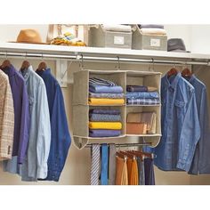 an organized closet with clothes and hats hanging on the hooks, including shirts and pants