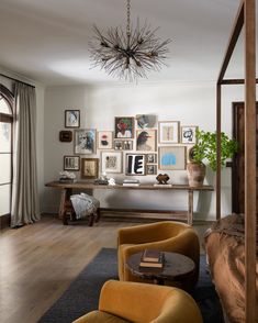 a living room filled with furniture and pictures on the wall