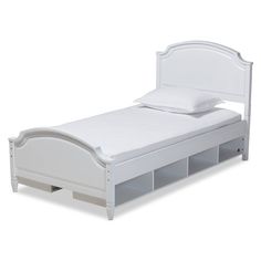 a white bed with drawers underneath it and a pillow on the top of the bed