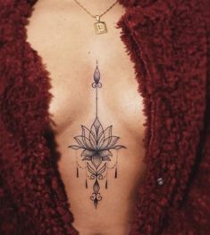 a woman's chest with a tattoo design on the top and bottom part of her body