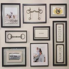 a bunch of framed pictures on the wall with some metal bars attached to them,