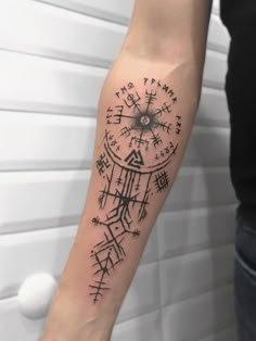 a person with a compass tattoo on their arm