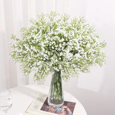 a vase filled with white flowers on top of a table