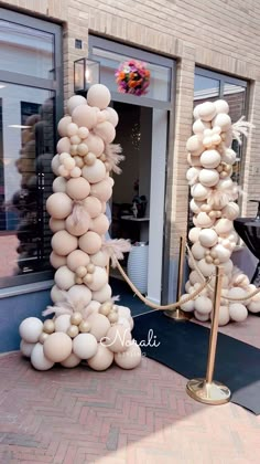 an outdoor display with balloons and ropes in front of a storefront door that says nabil