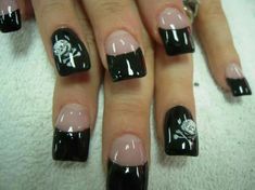 a woman with black and white nail designs on her nails