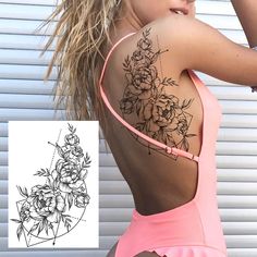 the back of a woman's swimsuit with flowers on it and a tattoo design