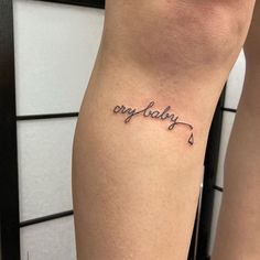 a woman's leg with a tattoo that says, only baby on it and an arrow