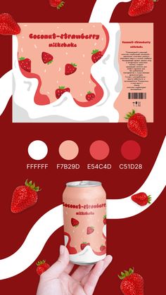 a hand holding a can of strawberry milk next to some strawberries on a red background