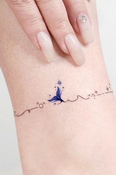 a woman's foot with a blue bird tattoo on her left ankle and the word love written across it