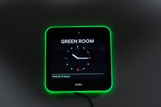 a green room clock with time for 2 hours on the screen and an arrow pointing up