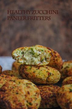 some food is stacked on top of each other with the words healthy zucchini paneer fritters