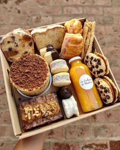 a box filled with different types of breads and condiments on top of each other