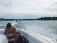 a man riding on the back of a white boat