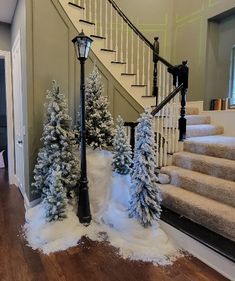 the stairs are decorated with snow and trees in front of them, along with a lamppost