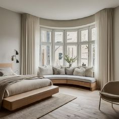 a large bed sitting next to a window in a bedroom