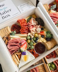 two white boxes filled with different types of food