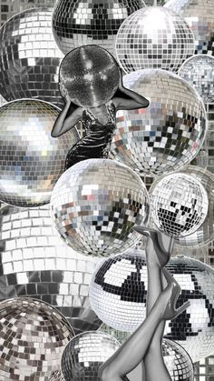 a woman is dancing in front of many disco ball shapes with her legs spread out