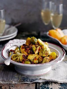 a white bowl filled with brussel sprouts on top of a table