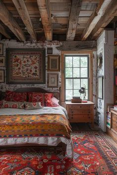 a bed in a room with lots of pictures on the wall and rugs around it