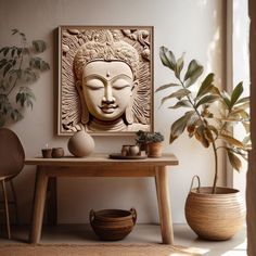 there is a buddha head on the wall next to a table with potted plants