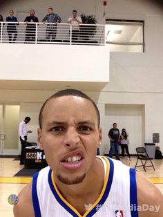 a man in a white and blue uniform holding a basketball