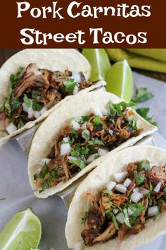 pork carnitas street tacos with limes and cilantro on the side