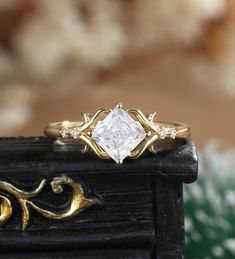 a close up of a ring with a diamond in it on top of a table