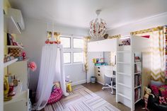 a bedroom with white walls and colorful curtains