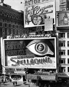 an old black and white photo of billboards