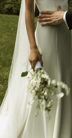 the bride and groom are holding each other's hands