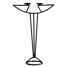 a black and white photo of a candle holder with three candles on each side, standing upright