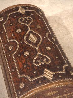 an old wooden box with intricate designs on it