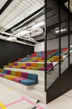 an empty room with colorful seats and stairs