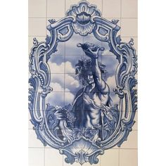 a blue and white tile wall with an image of a woman holding a bird on it