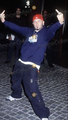 a man in blue shirt and red hat dancing