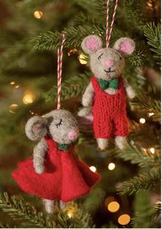 two ornaments are hanging from a christmas tree